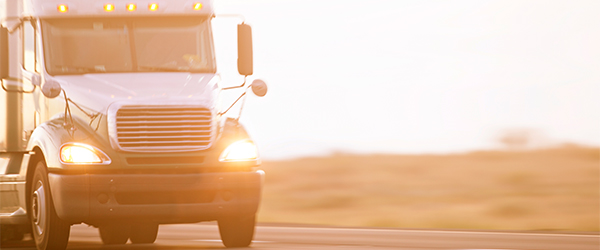 A semi truck driving down a highway)