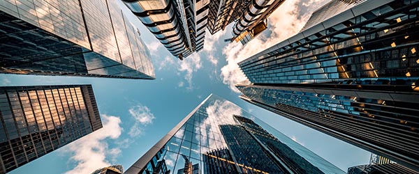 Looking up toward a blue sky from the ground in an urban setting)