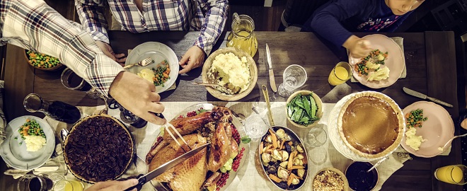 Overhead shot of a holiday dinner table with family around the table)