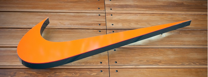 Orange Nike swoosh on wood background)