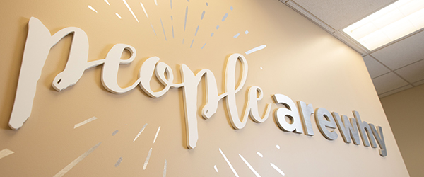 A wall banner at the IGS Energy headquarters that reads "People Are Why"