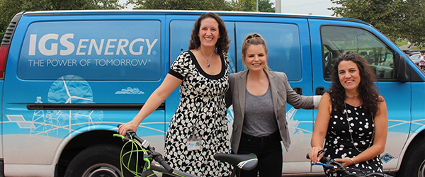 Employees with bikes in front of IGS Energy Van)