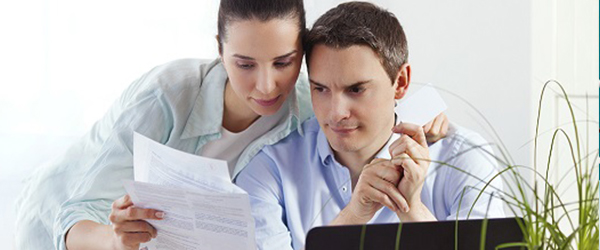Couple reviewing electric and natural gas bill Generation Transmission Supply Charges) Couple reviewing electric and natural gas bill Generation Transmission Supply Charges