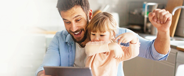 Father and daughter on laptop)